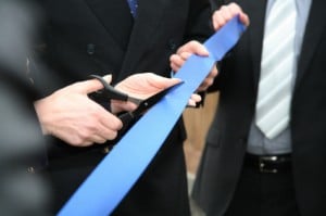 Image of a person cutting a blue ribbon on PSA Insurance & Financial Services in Maryland's website