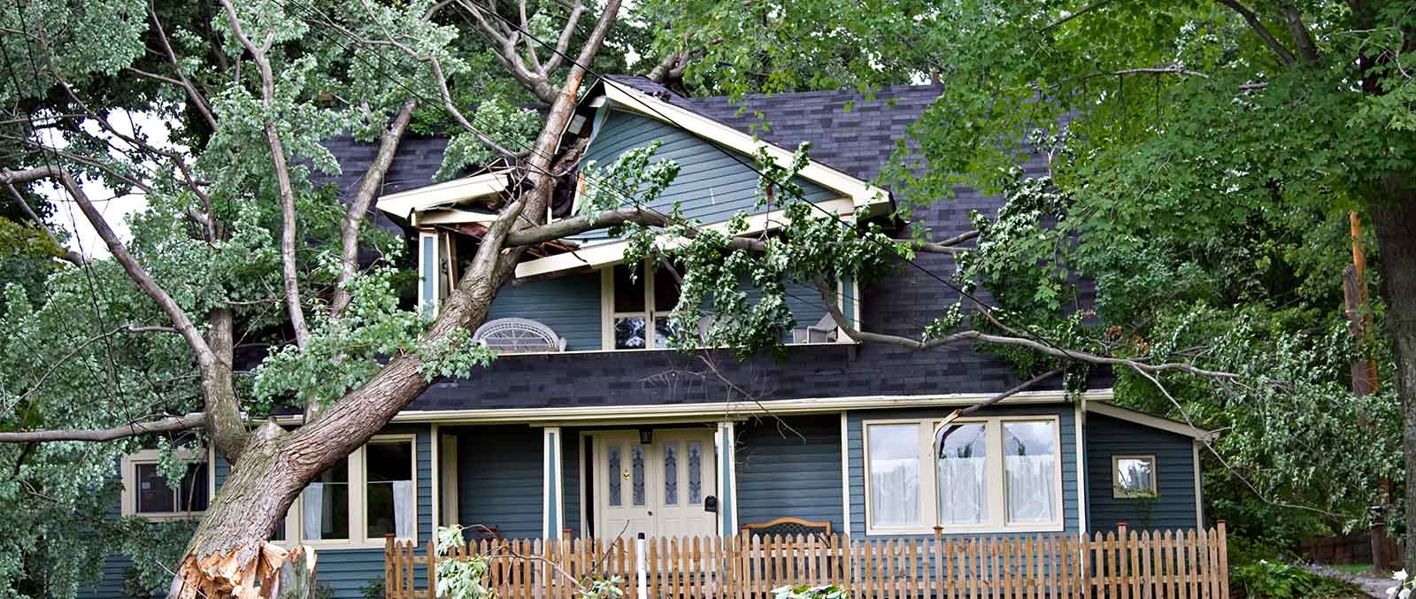 Image of a house with hurricane damage on PSA Insurance & Financial Services' website
