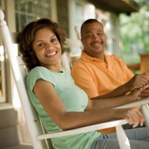 Image of a couple smiling and sitting in rocking chairs on PSA Insurance & Financial Services' website