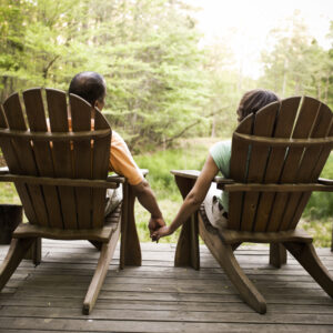Image of a couple holding hands in outdoor chairs on PSA Insurance & Financial Services' website