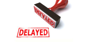 Image of a rubber stamp and the word Delayed in red on PSA Financial's website