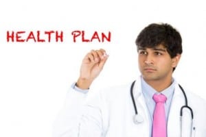 Image of a doctor writing the words "health plan" on PSA Insurance and Financial Services' website