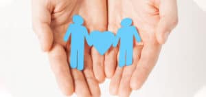 Hands holding cutouts of a same-sex couple and a heart on PSA Financial's website