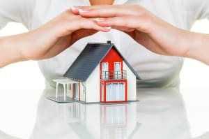 Image of a woman's hands over a mini house on PSA Insurance and Financial Services' website
