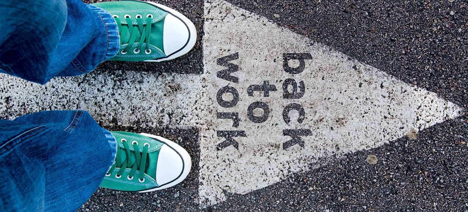 Image of pavement with a white arrow reading "back to work" on PSA Insurance & Financial Services' website