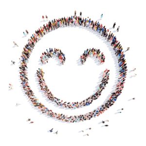 Image of people standing in the shape of a smiley face