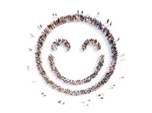 Image of people standing in the shape of a smiley face