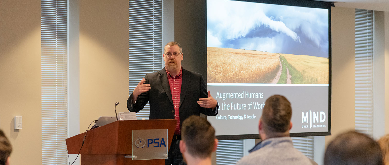 IImage of a man talking at a PSA conference on PSA Insurance & Financial Services' website