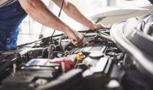 Mechanic working on a car engine on PSA Insurance & Financial Services' website