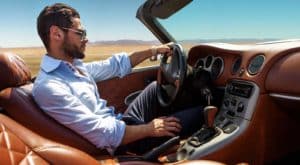 Image of a man driving a car that may need Luxury and Exotic Car Insurance on PSA Insurance & Financial Services' website
