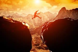 Image of a person leaping from one cliff to another on PSA Insurance & Financial Services' website