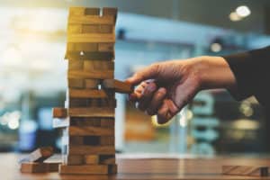 Image of a person removing a block from a Jenag tower on PSA Insurance & Financial Services' website