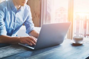 Image of a man using a laptop at a desk on PSA Insurance & Financial Services' website