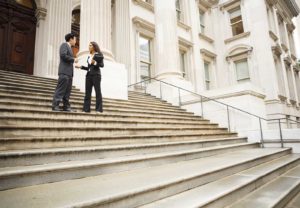 two business people in front of a government building