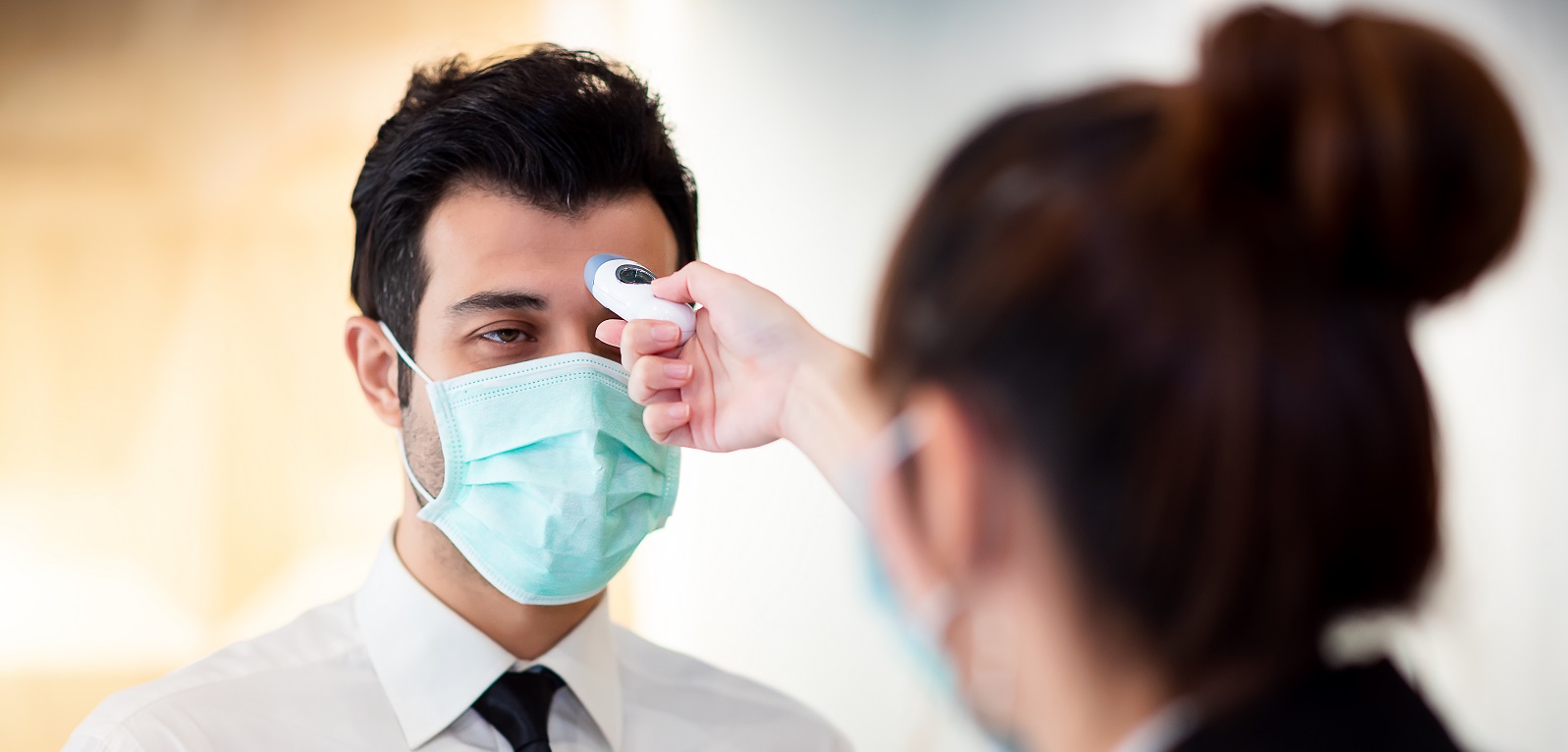 Image of a person taking another person's temperature on PSA Financial's website