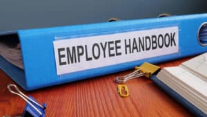 Image of a binder reading "Employee Handbook" on PSA Financial's website