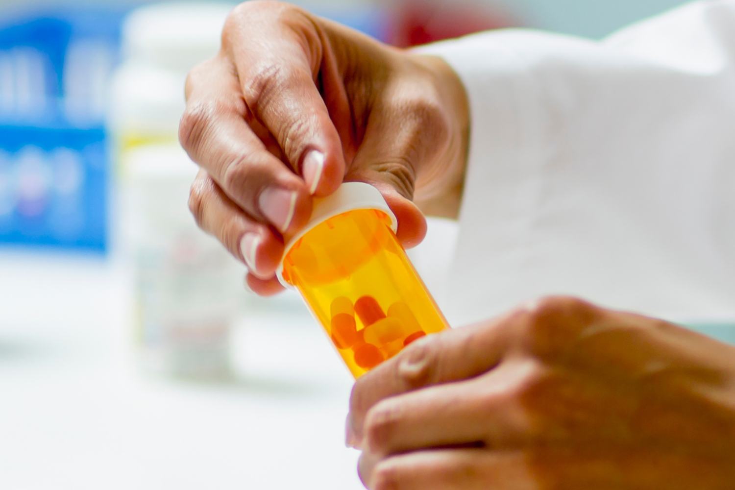Image of a pharmacist holding a bottle of pills