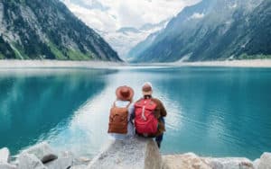 Image of a pair of people at a lake with mountains in the background on PSA Financial's website