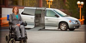 Business woman in a powered chair outside of her mini van on PSA Insurance & Financial Services' website