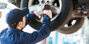 Image of a mechanic putting on a tire on PSA Insurance & Financial Services' website