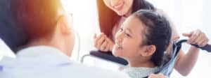 Image of a little girl in a wheelchair smiling on PSA Insurance & Financial Services' website