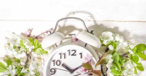 Image of an alarm clock inside a wreath