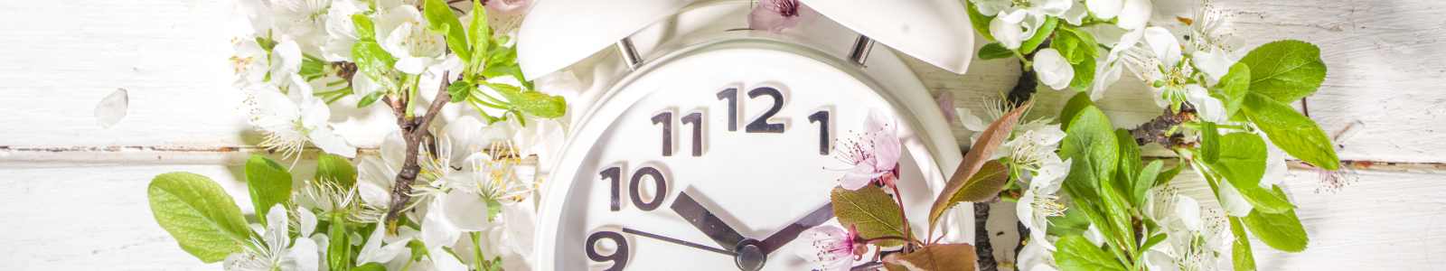 Image of an alarm clock inside a wreath