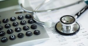 Image of a calculator and stethescope