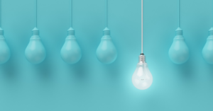 Image of blue lightbulbs with one illuminated