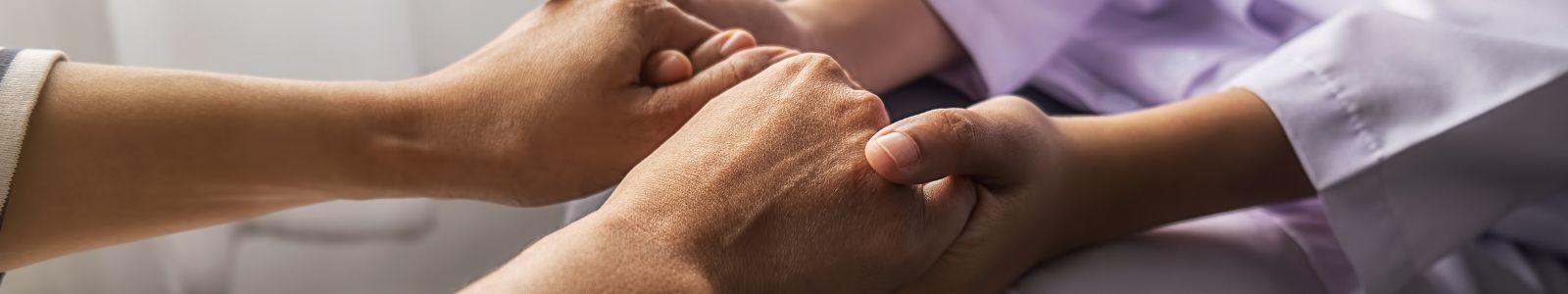 Image of a person holding another person's hands