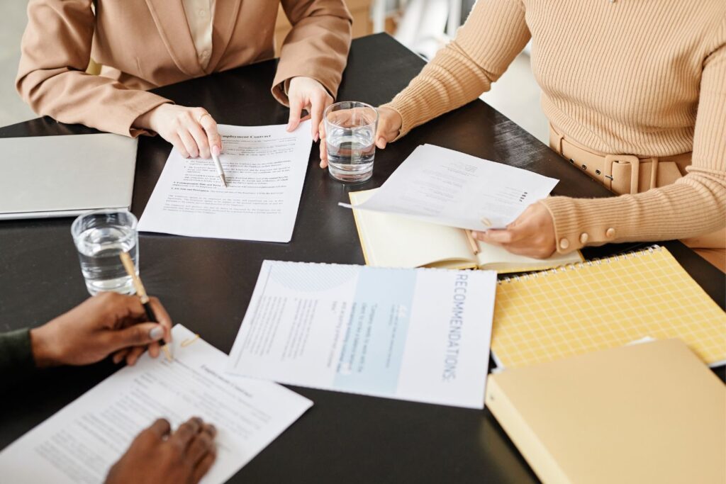 Image of people consulting over documents at a desk