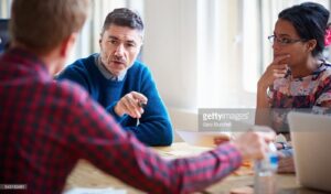 Image of people consulting at a desk