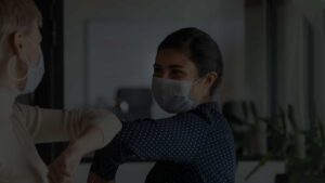 Image of two people wearing masks