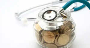 Image of a jar of coins and a stethoscope