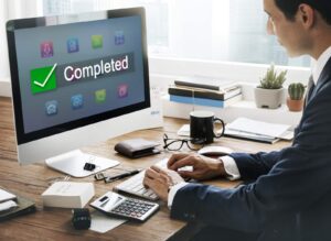 Image of a man using a desktop computer
